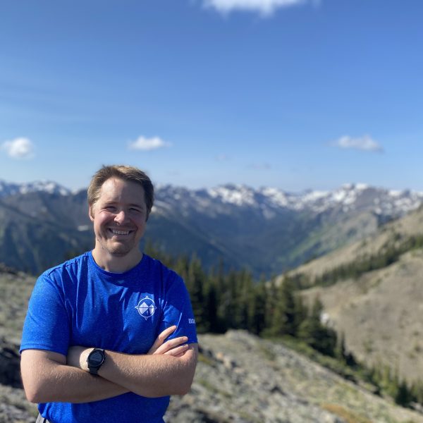Physical therapist Chad Boehm stands on a mountain trail.