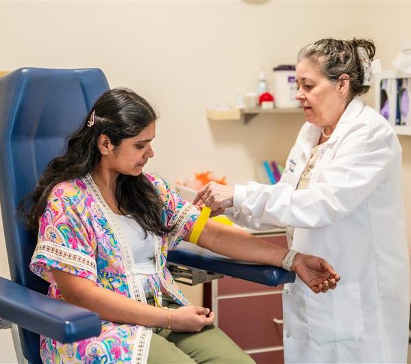 Patient in lab preparing for blood draw.